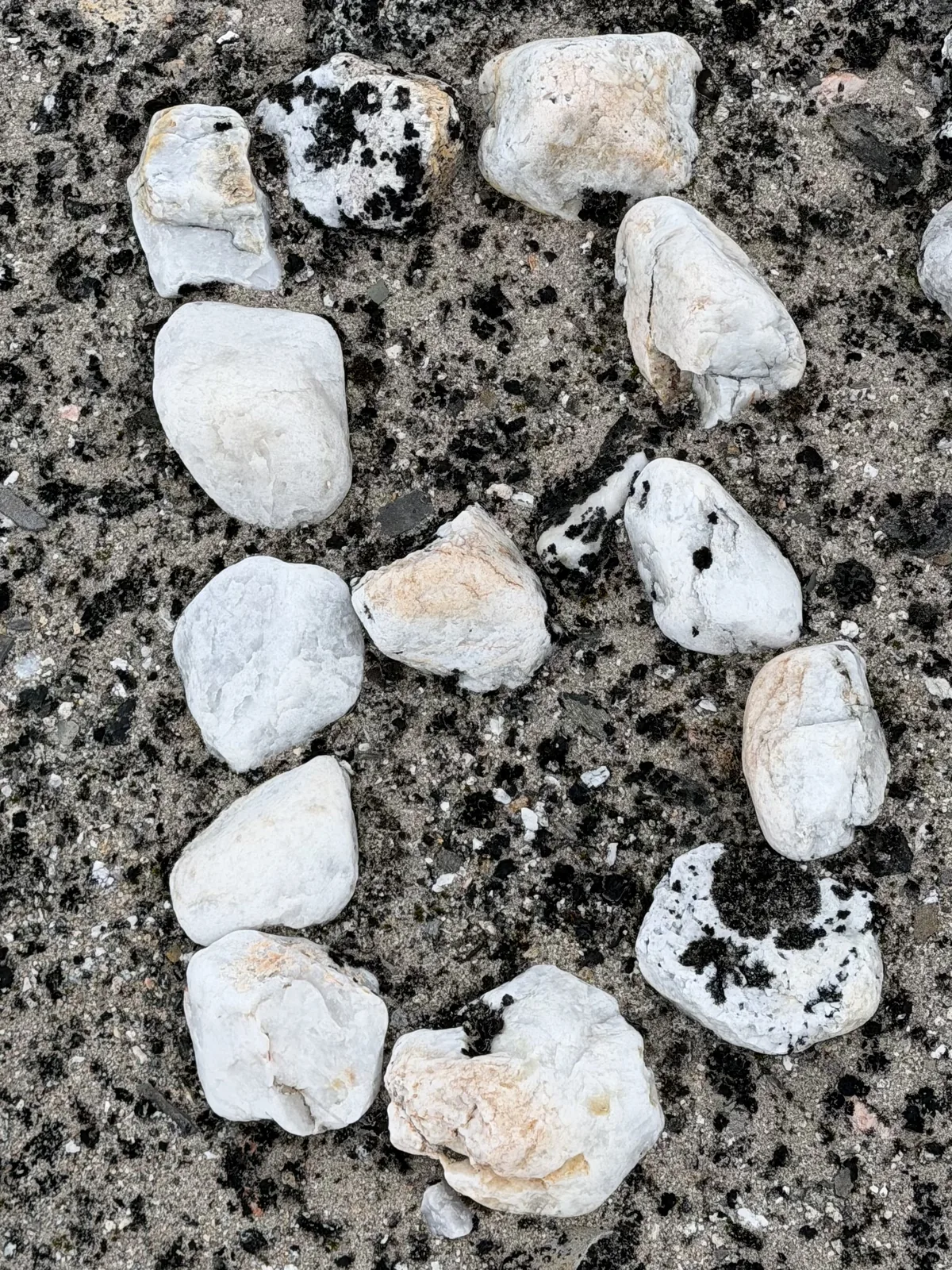 White stones laid into figures on gravel