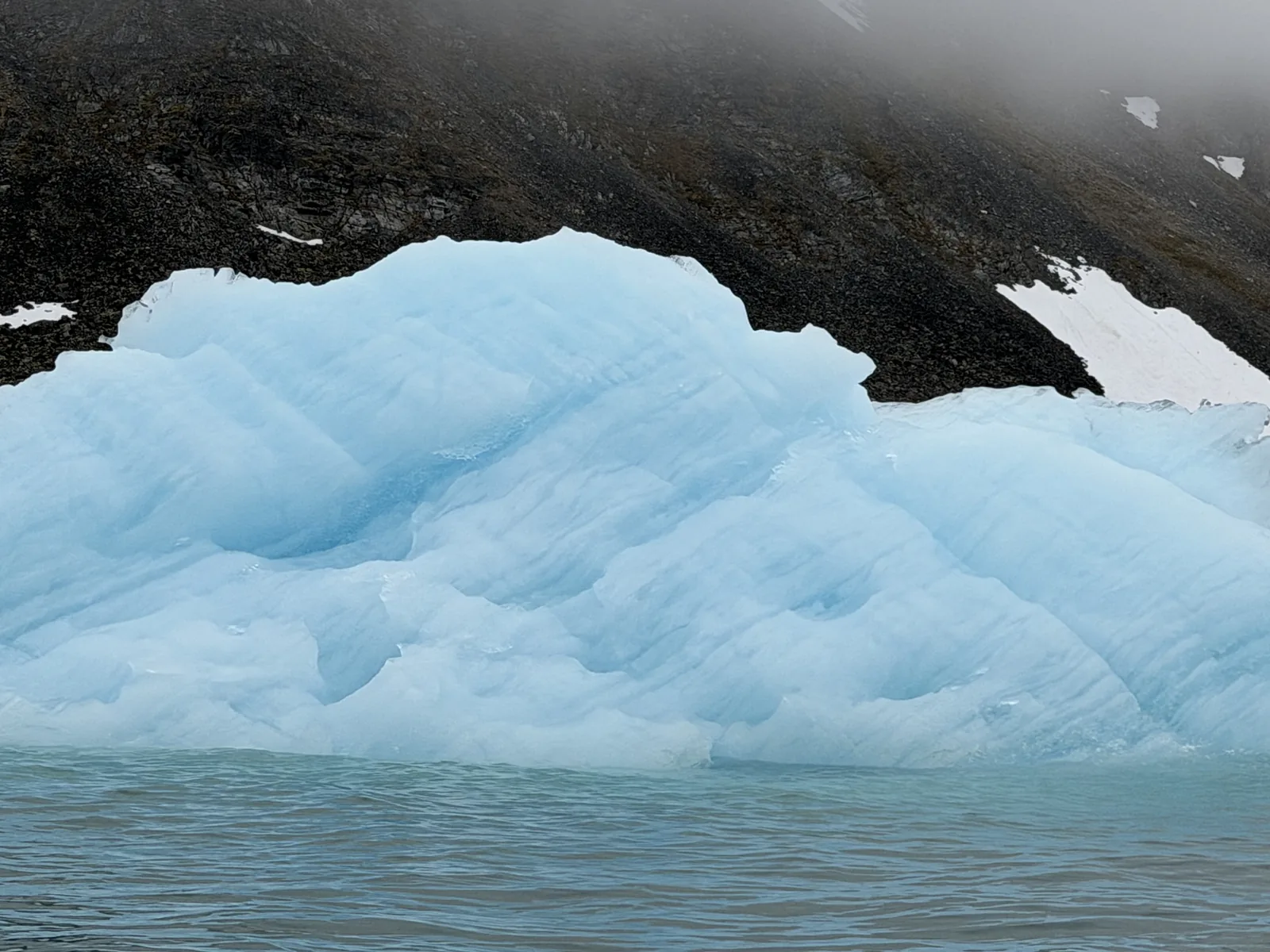 A blue iceberg worn into an arch